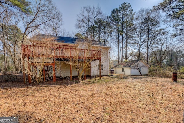 exterior space featuring an outdoor structure and a deck