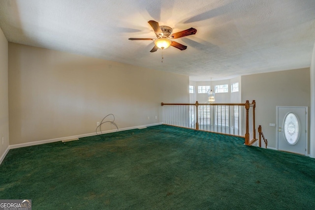 empty room with ceiling fan, carpet floors, and a textured ceiling