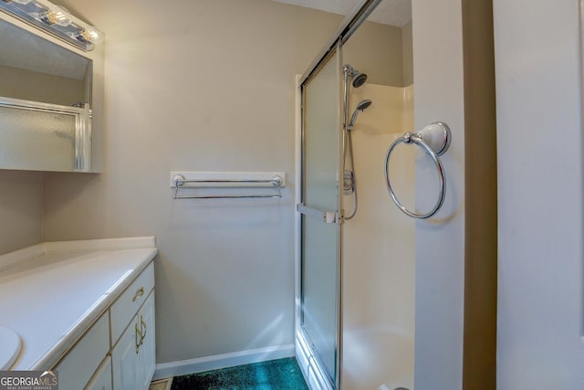 bathroom with vanity and a shower with shower door