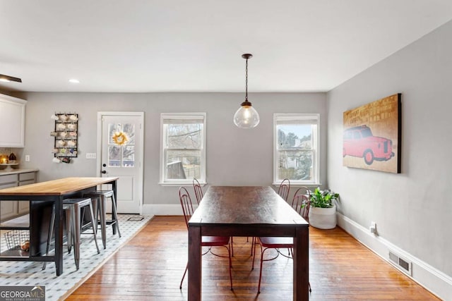 dining room with a wealth of natural light and light hardwood / wood-style flooring