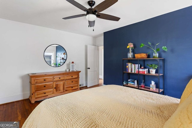 bedroom featuring dark hardwood / wood-style flooring and ceiling fan