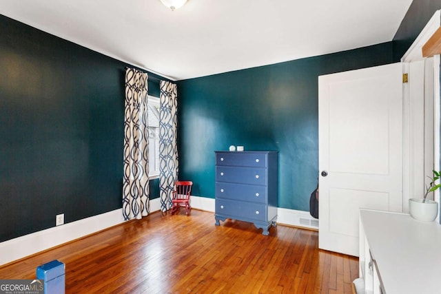 bedroom with hardwood / wood-style flooring