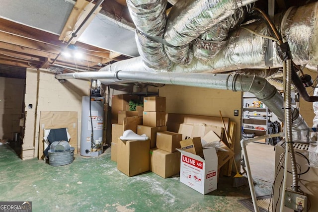 basement with gas water heater and refrigerator