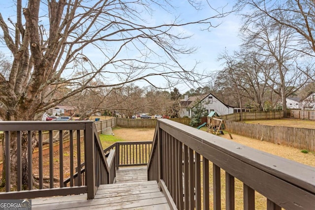 deck featuring a yard and a playground