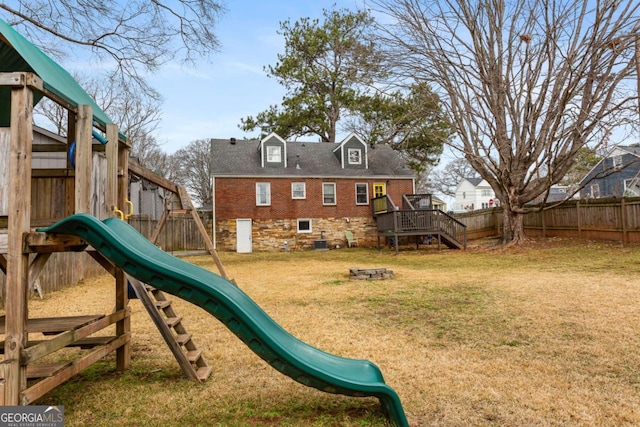 view of jungle gym featuring a lawn