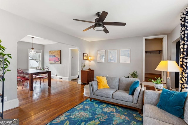 living room featuring hardwood / wood-style flooring and ceiling fan