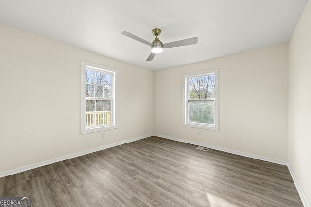 empty room featuring dark hardwood / wood-style floors and ceiling fan