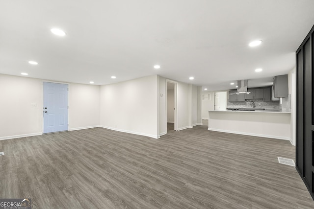 unfurnished living room featuring dark wood-type flooring