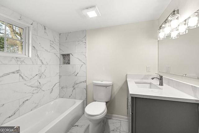 full bathroom featuring vanity, tiled shower / bath, and toilet