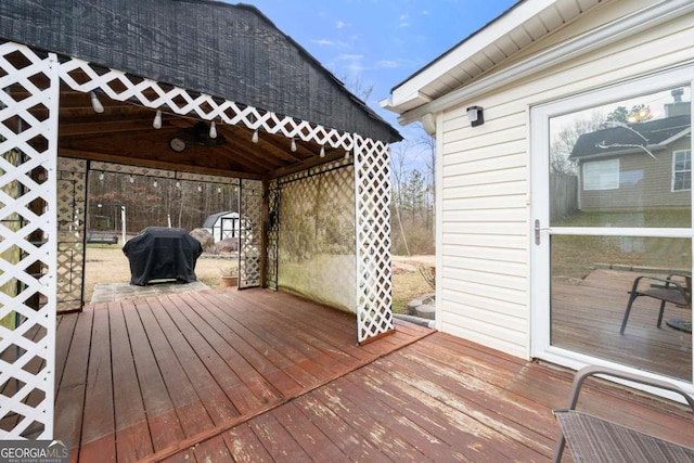 wooden deck featuring a grill