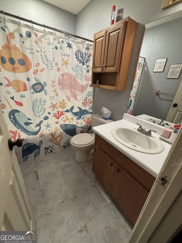 bathroom with vanity, tile patterned flooring, toilet, and walk in shower