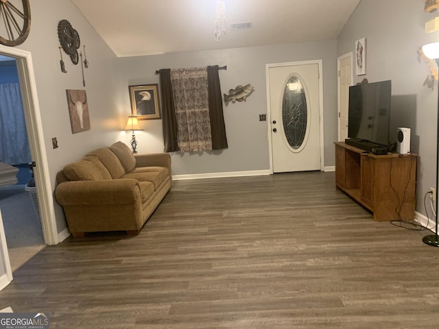 living room with dark wood-type flooring and vaulted ceiling