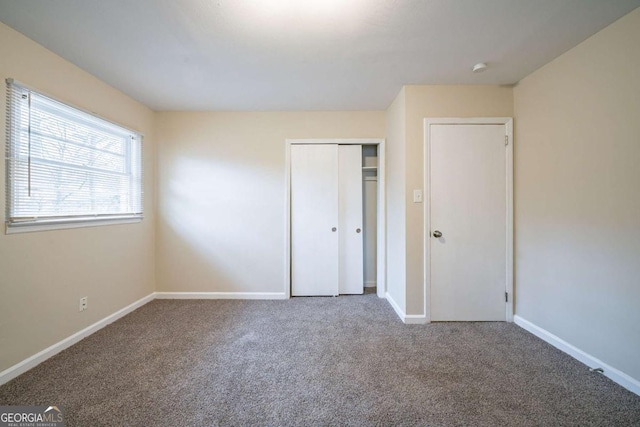 unfurnished bedroom featuring a closet and carpet flooring