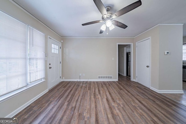 unfurnished room with crown molding, dark hardwood / wood-style floors, and ceiling fan