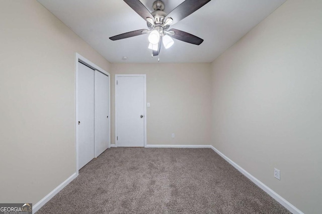 unfurnished bedroom featuring carpet floors, a closet, and ceiling fan