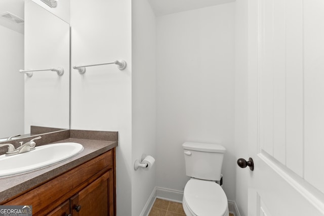 bathroom with vanity, tile patterned flooring, and toilet