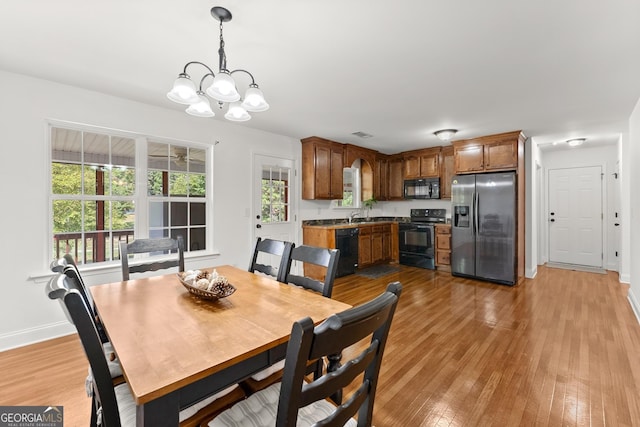 dining area featuring a chandelier and light hardwood / wood-style floors