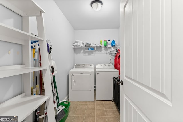 washroom with washing machine and dryer and light tile patterned floors