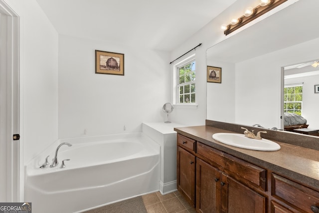 bathroom featuring tile patterned floors, vanity, and a bathing tub