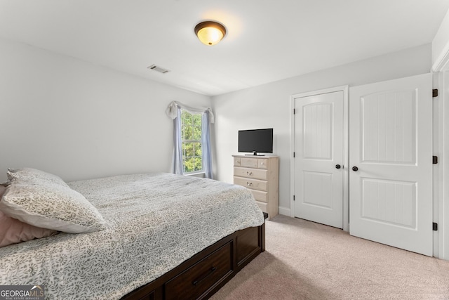 carpeted bedroom with a closet