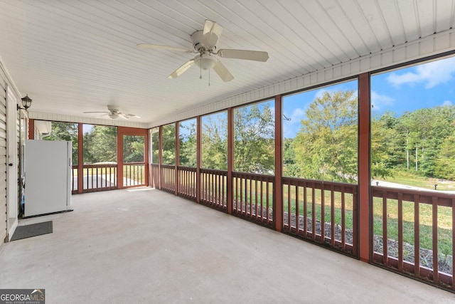 unfurnished sunroom featuring ceiling fan