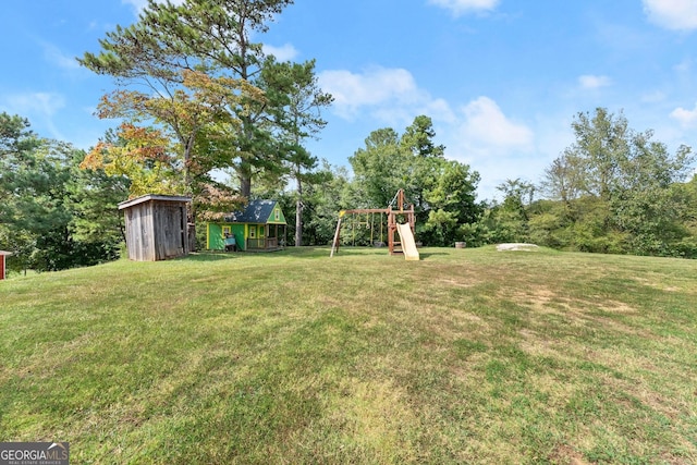 view of yard featuring a playground and a shed