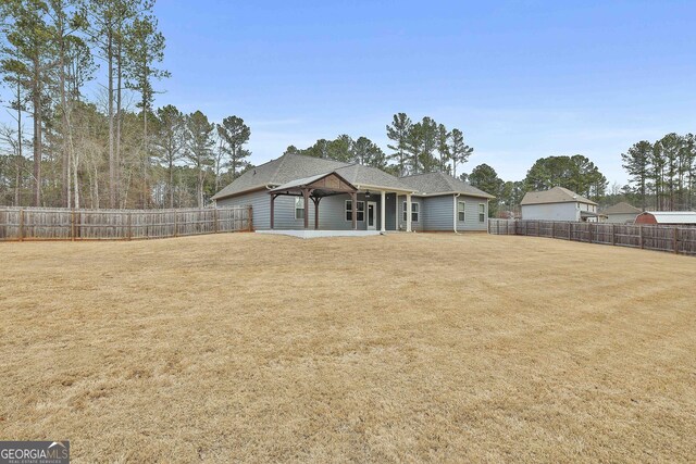 view of front of house with a fenced backyard and a front lawn