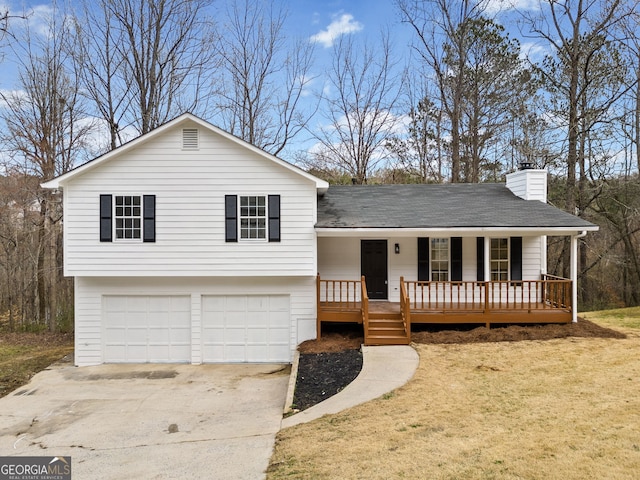 split level home featuring a garage and a porch