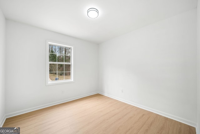 empty room with light hardwood / wood-style flooring