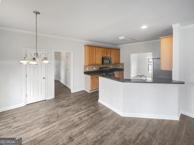 kitchen with crown molding, decorative light fixtures, black appliances, and kitchen peninsula