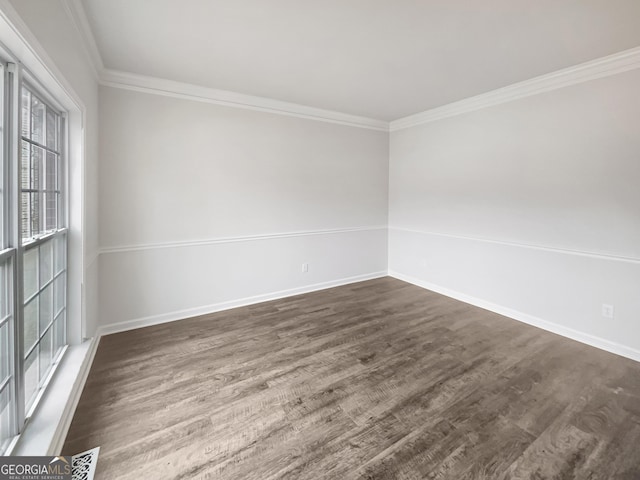 spare room with crown molding and dark hardwood / wood-style floors