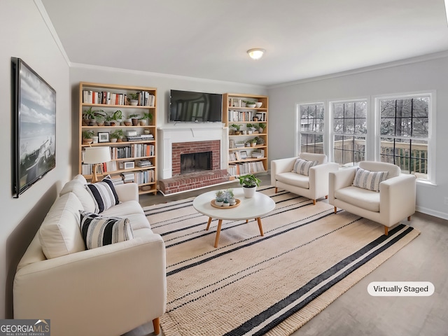 living room featuring a brick fireplace, crown molding, built in shelves, and hardwood / wood-style flooring