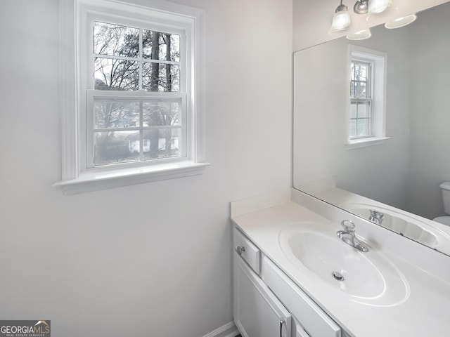 bathroom featuring vanity and toilet