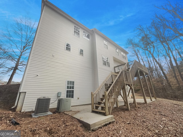 back of property featuring cooling unit and a deck