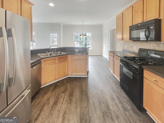 kitchen featuring sink, hanging light fixtures, black appliances, crown molding, and dark wood-type flooring