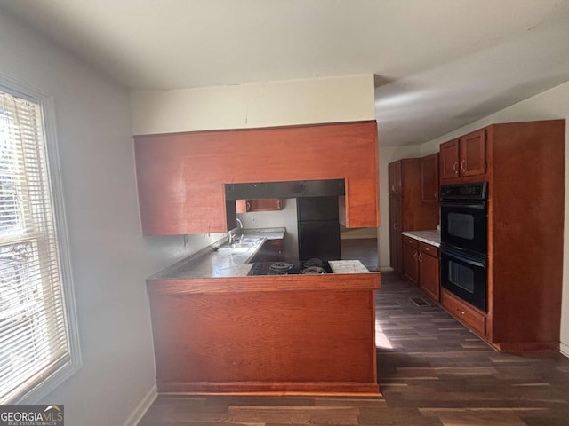 kitchen with dark hardwood / wood-style floors, kitchen peninsula, and double oven