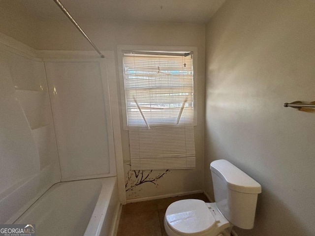 bathroom with bathing tub / shower combination and toilet