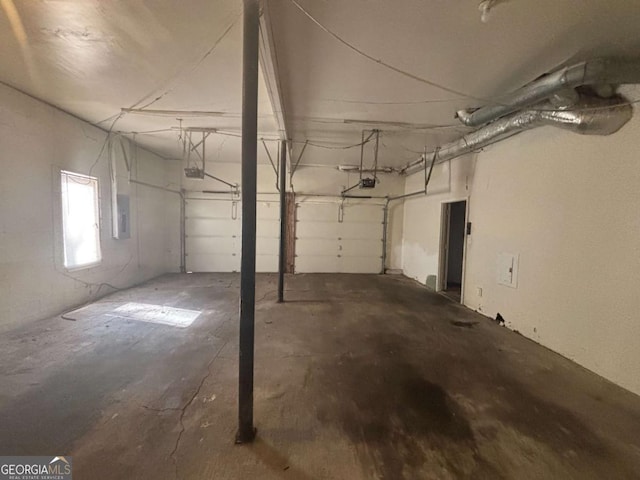 garage with a garage door opener and electric panel