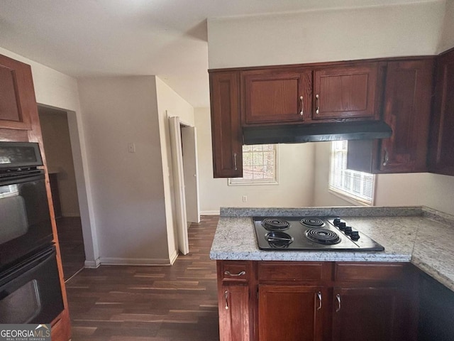 kitchen with dark wood-type flooring, black double oven, electric stovetop, and light stone countertops