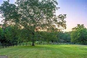 view of yard with a rural view and fence