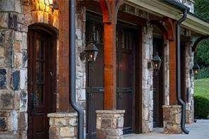 property entrance featuring stone siding