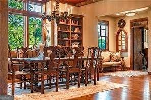 dining area featuring a chandelier and wood finished floors