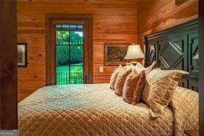 bedroom featuring wooden walls