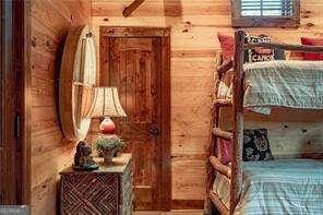 bedroom with wood walls