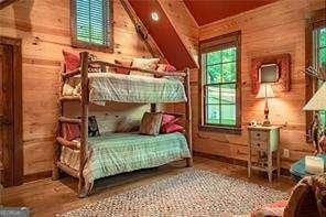 bedroom featuring wood walls