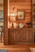 bar featuring wood walls and wood finished floors