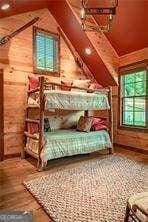 bedroom with lofted ceiling and wood finished floors