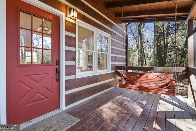 property entrance with a wooden deck