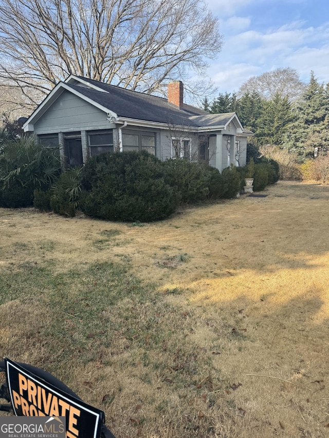 view of side of property with a yard