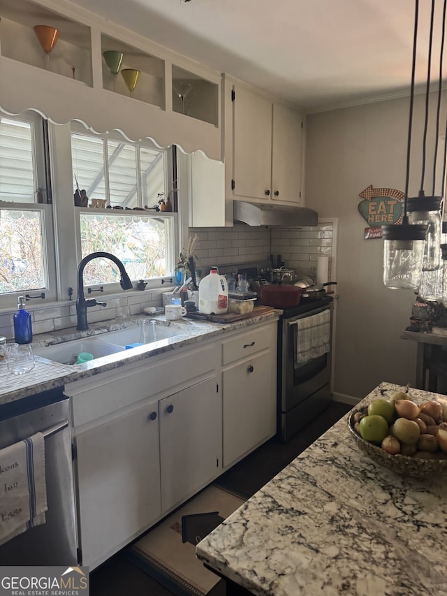 kitchen featuring sink, stainless steel appliances, white cabinets, and light stone countertops